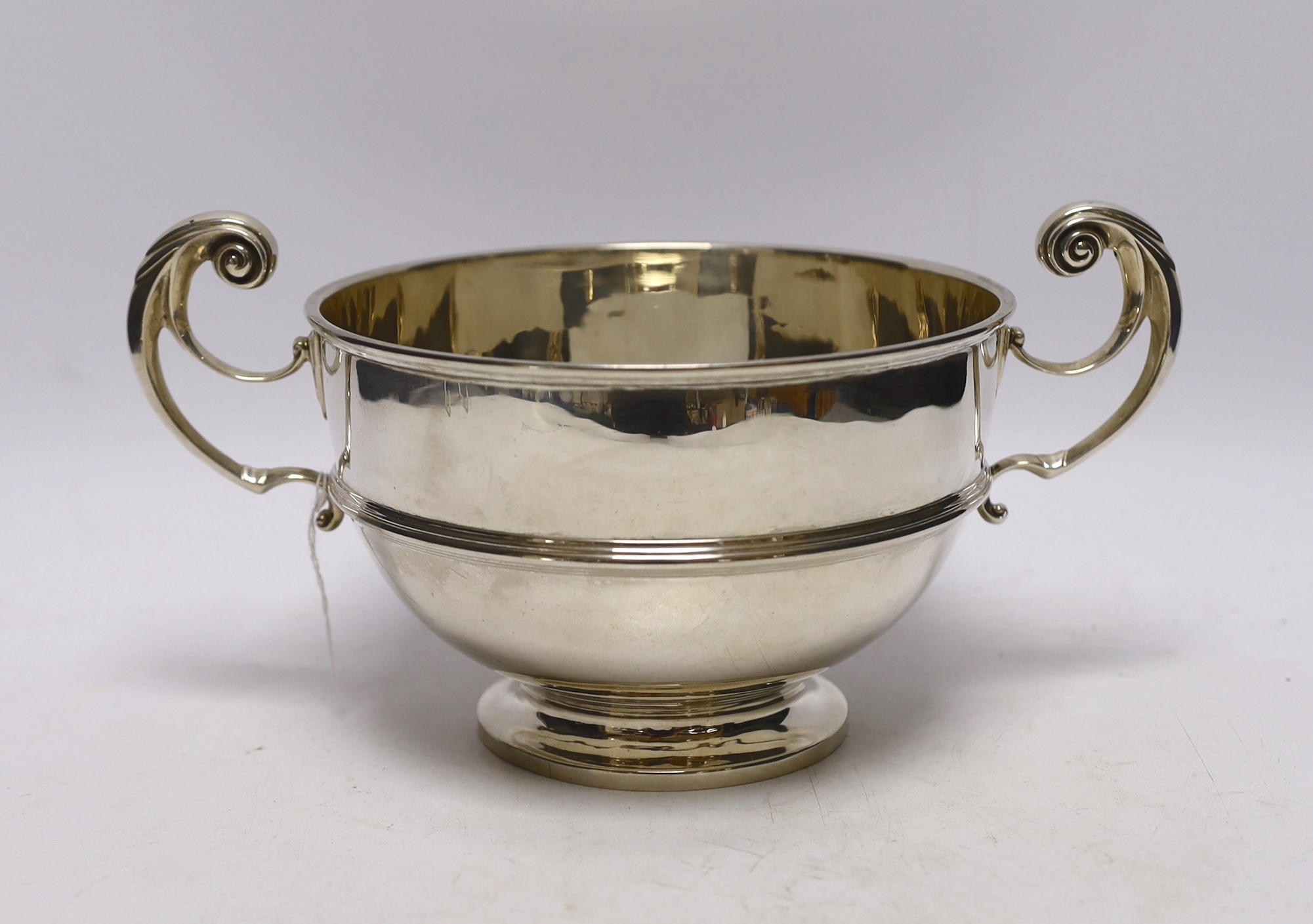 An Edwardian silver two handled bowl, with banded girdle, Goldsmiths & Silversmiths Co Ltd, London, 1908, 27cm over handles, 18.5oz.